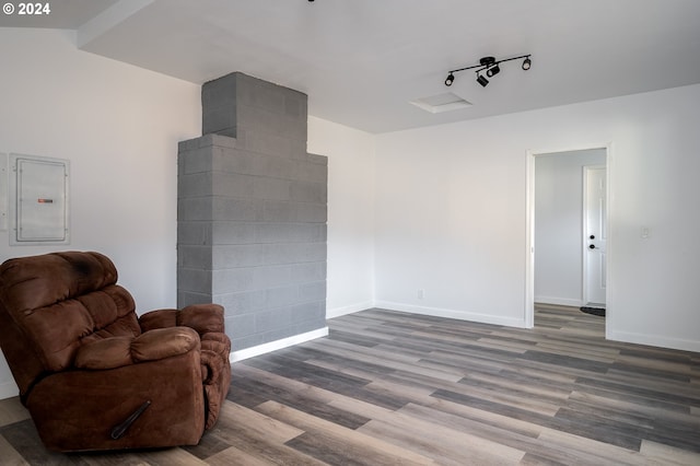 living area featuring electric panel and hardwood / wood-style flooring