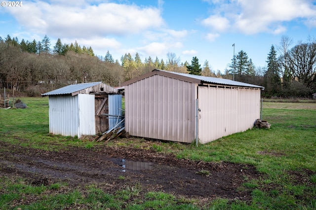 view of outbuilding featuring a yard