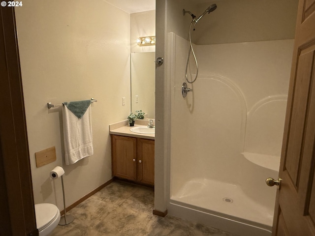 9845 N Lombard St, Portland, OR 97203 - bathroom with a shower, vanity, toilet, and baseboards