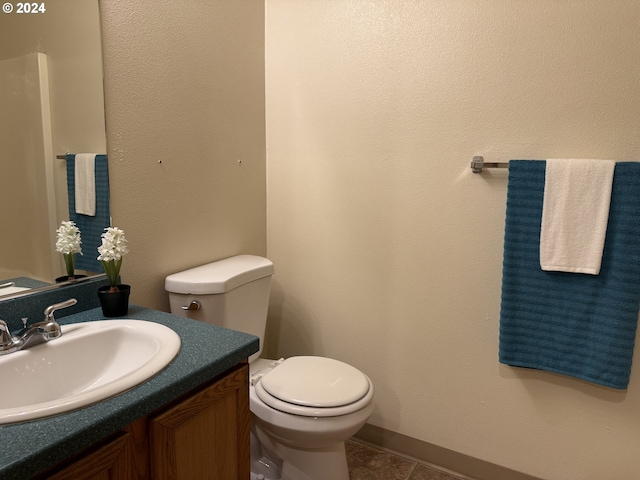 9845 N Lombard St, Portland, OR 97203 - half bath featuring vanity, toilet, and tile patterned flooring