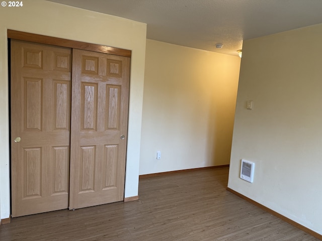 9845 N Lombard St, Portland, OR 97203 - unfurnished bedroom featuring wood finished floors, baseboards, and a closet