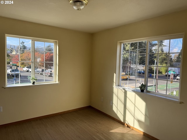 9845 N Lombard St, Portland, OR 97203 - empty room featuring baseboards and light wood-style floors