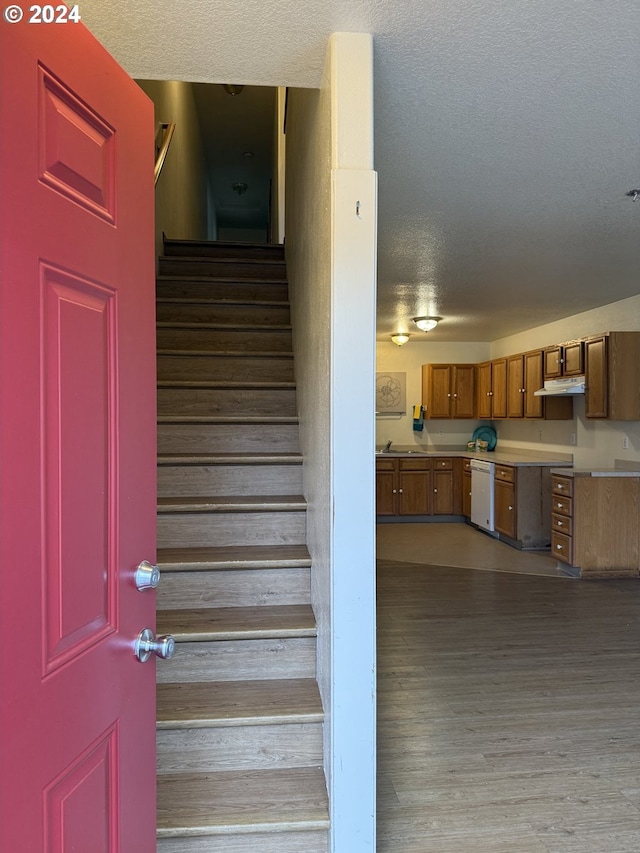 9845 N Lombard St, Portland, OR 97203 - stairs featuring a textured ceiling and wood finished floors