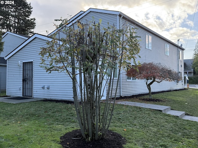 9845 N Lombard St, Portland, OR 97203 - view of side of property featuring a lawn
