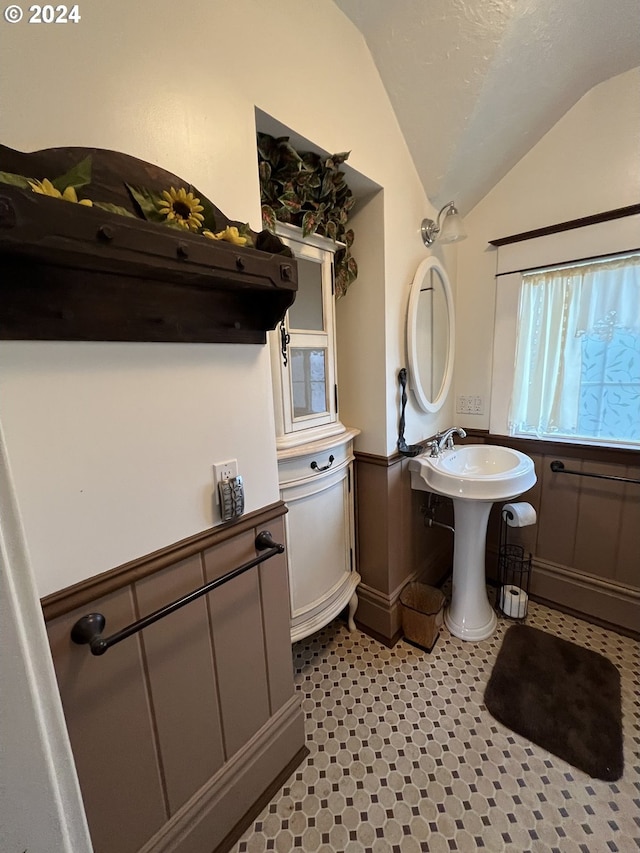 bathroom featuring lofted ceiling