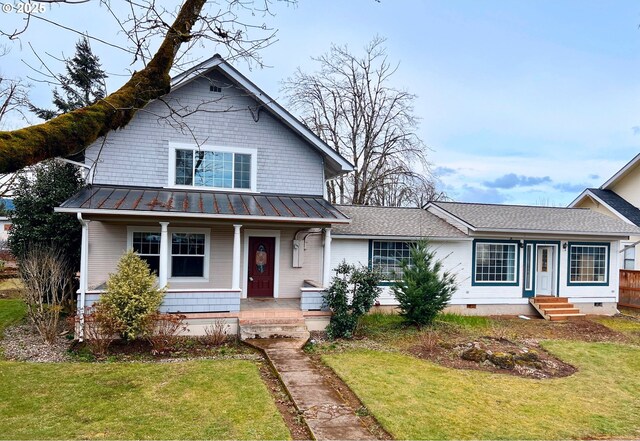 view of front of home with covered porch and a front lawn