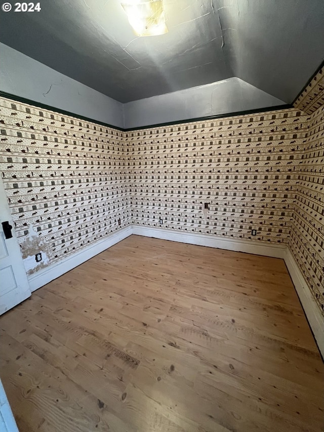 bonus room with vaulted ceiling and wood finished floors