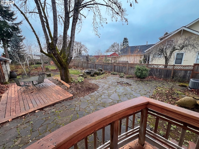 wooden deck with a patio, outdoor dining space, a fenced backyard, and central air condition unit