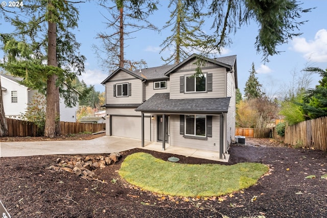 view of front of property with central AC unit and a garage