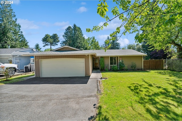 ranch-style house with a garage and a front lawn