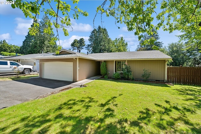 ranch-style home featuring a garage and a front yard