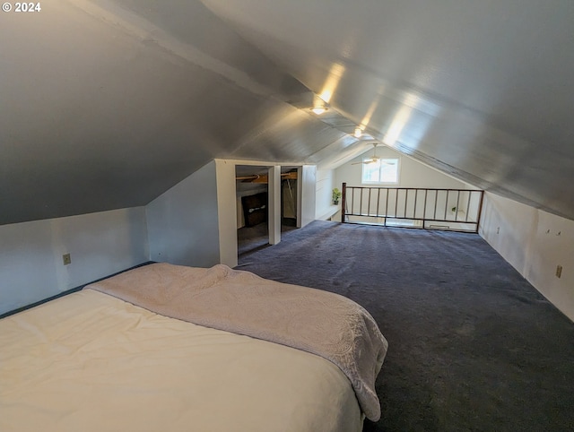 unfurnished bedroom featuring lofted ceiling and carpet flooring