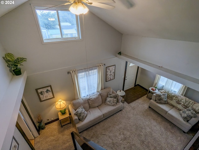 carpeted living room with ceiling fan and high vaulted ceiling