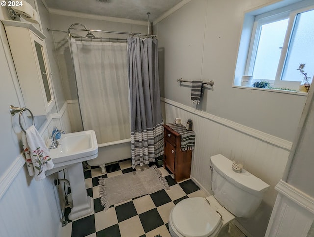 full bath featuring tile patterned floors, a decorative wall, wainscoting, and toilet