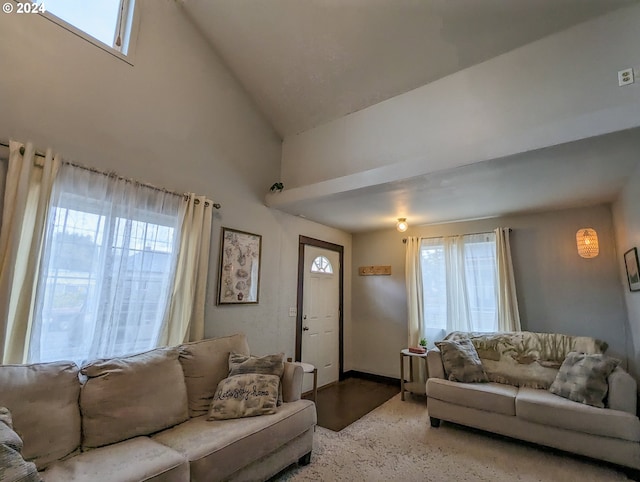 living room with a healthy amount of sunlight and high vaulted ceiling