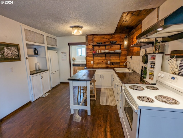 kitchen with white appliances, a textured ceiling, decorative light fixtures, and dark hardwood / wood-style flooring