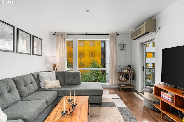 living room featuring an AC wall unit and dark hardwood / wood-style floors