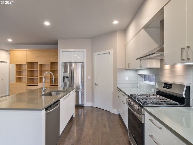 kitchen with sink, white cabinets, stainless steel appliances, dark wood-type flooring, and a center island with sink