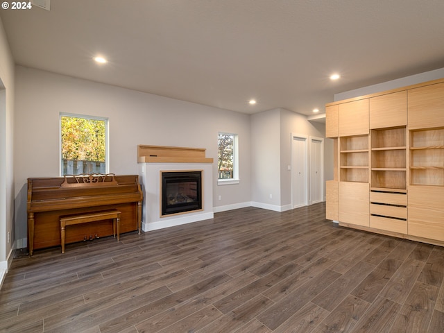 unfurnished living room with dark hardwood / wood-style flooring