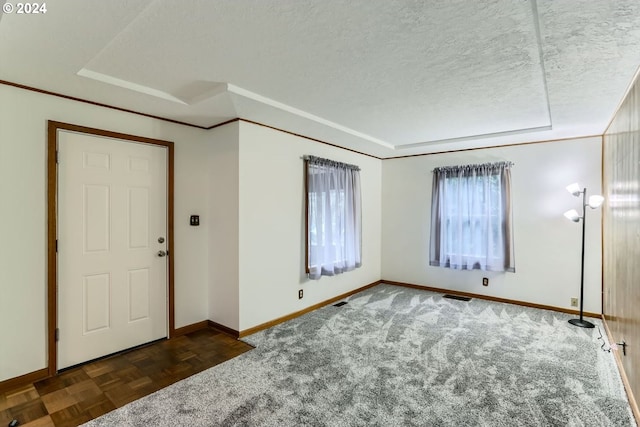 entryway with dark parquet flooring and a textured ceiling