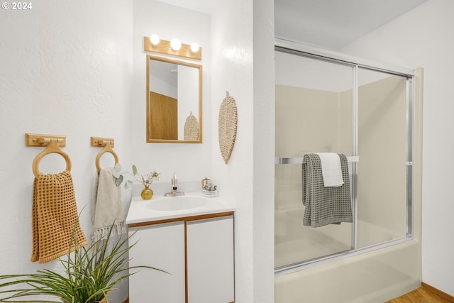 full bathroom with vanity and shower / bath combination with glass door