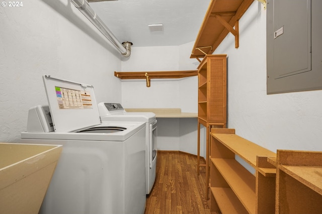 washroom with electric panel, laundry area, dark wood-style flooring, and separate washer and dryer