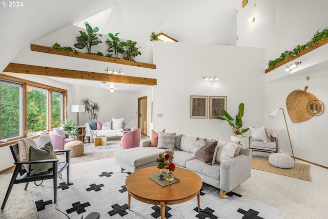 living room with beam ceiling, light colored carpet, and high vaulted ceiling