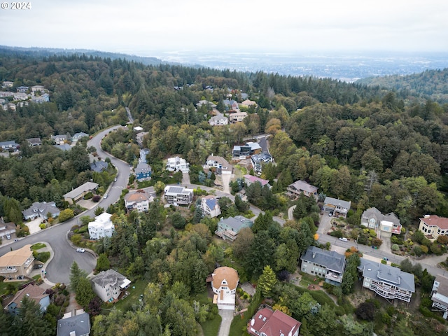 drone / aerial view featuring a forest view and a residential view