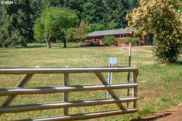 view of yard with a rural view and a deck