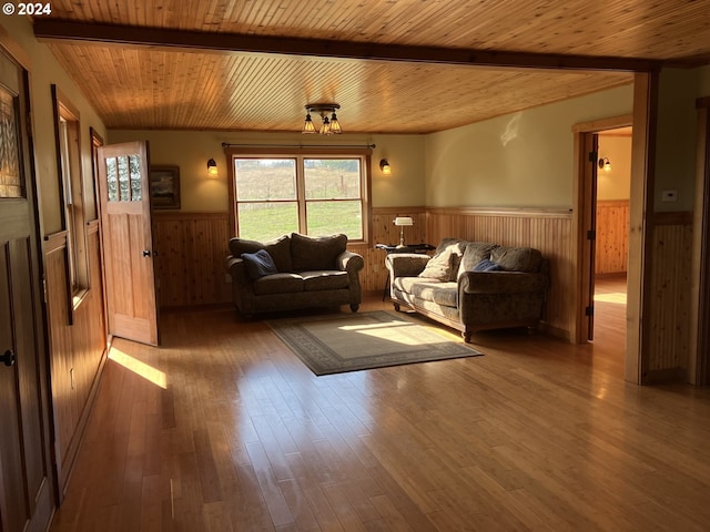 26231 SW Thunderhead Ln, Sheridan, OR 97378 - living area featuring a wainscoted wall, wood ceiling, healthy amount of natural light, wooden walls, and hardwood / wood-style floors