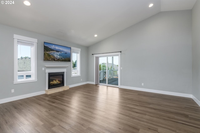 unfurnished living room featuring vaulted ceiling and hardwood / wood-style floors