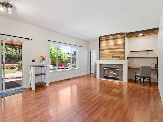 unfurnished living room featuring hardwood / wood-style flooring and a fireplace