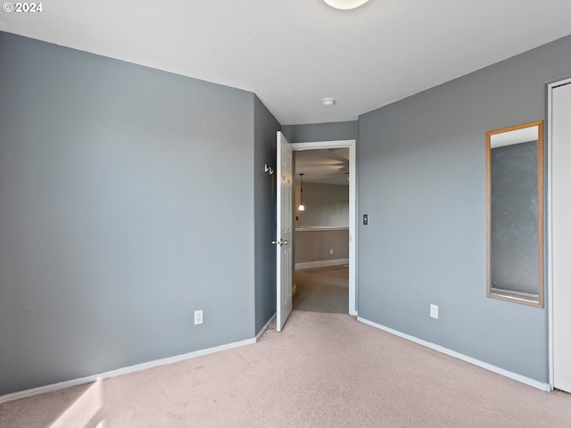 empty room featuring light carpet