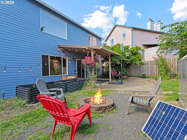 back of house featuring a patio and a fire pit