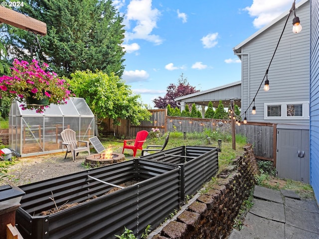 view of yard featuring an outbuilding and a fire pit