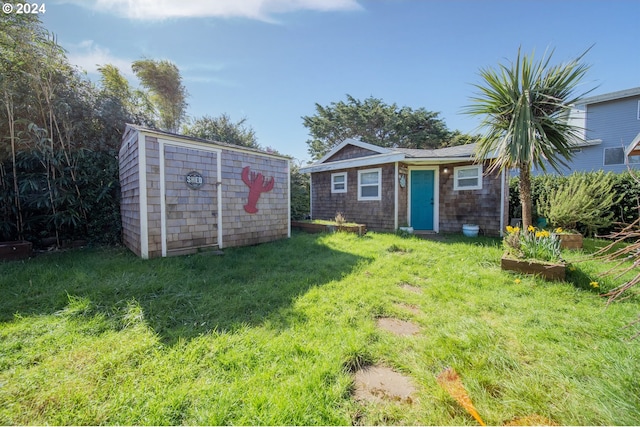 view of outbuilding featuring a lawn