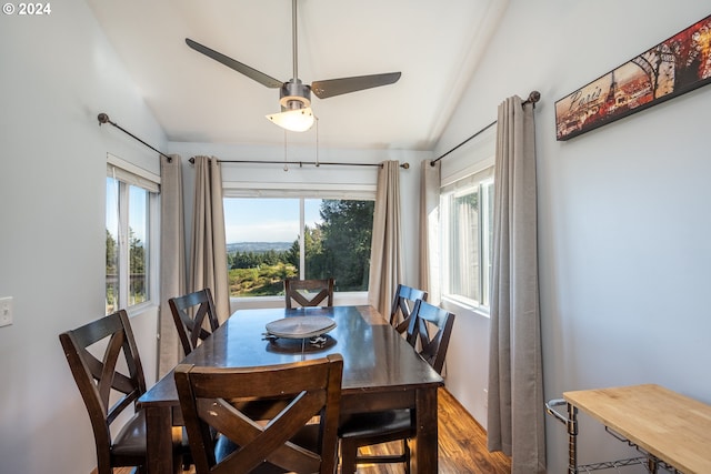 dining space featuring wood-type flooring, vaulted ceiling, and ceiling fan