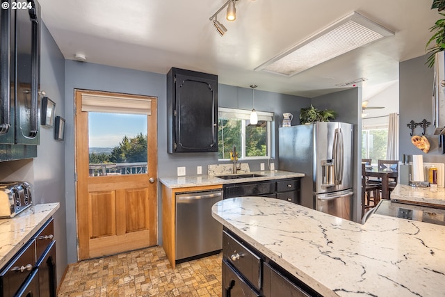 kitchen featuring appliances with stainless steel finishes, sink, and a wealth of natural light