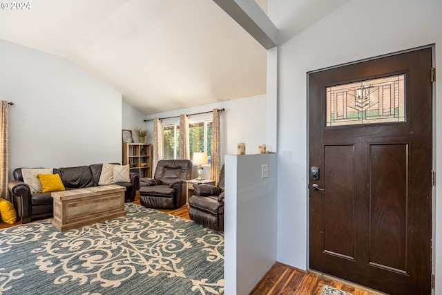 entryway with wood-type flooring and vaulted ceiling