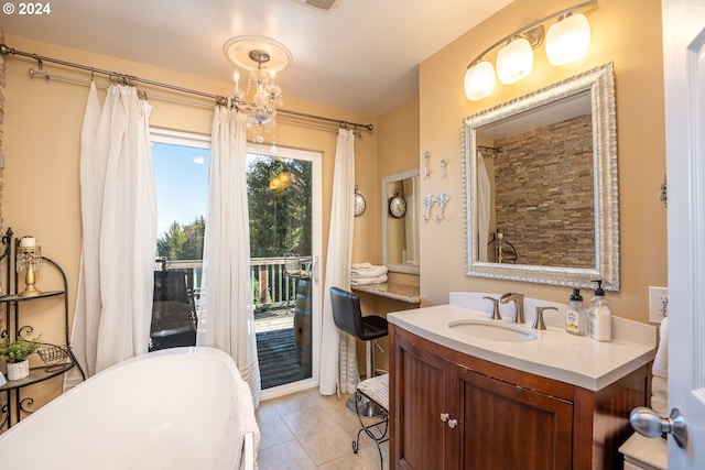 bathroom featuring tile patterned flooring, a washtub, and vanity