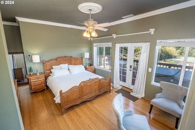 bedroom with access to exterior, crown molding, ceiling fan, light hardwood / wood-style flooring, and french doors