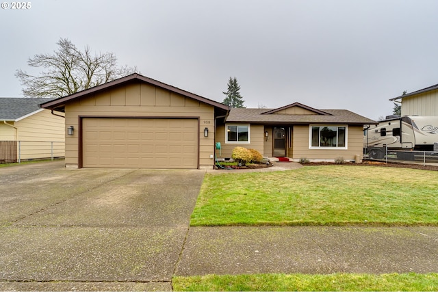 ranch-style home featuring a front yard and a garage