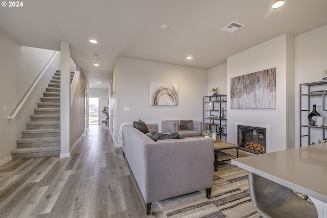 3594 Ash St, Forest Grove, OR 97116 - living room featuring a glass covered fireplace, stairway, recessed lighting, and light wood-type flooring
