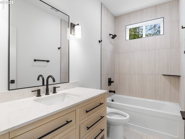 full bathroom with vanity, tiled shower / bath combo, and toilet