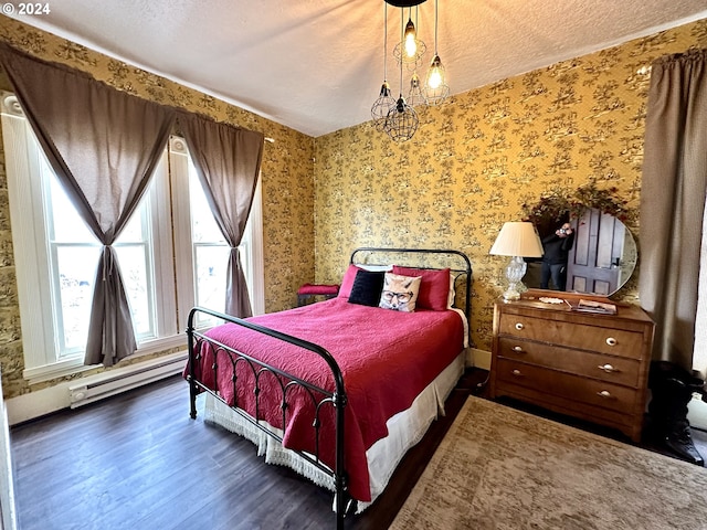 bedroom with a baseboard radiator, dark wood-type flooring, a textured ceiling, and an inviting chandelier