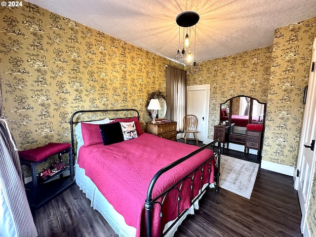 bedroom with a textured ceiling and dark hardwood / wood-style flooring