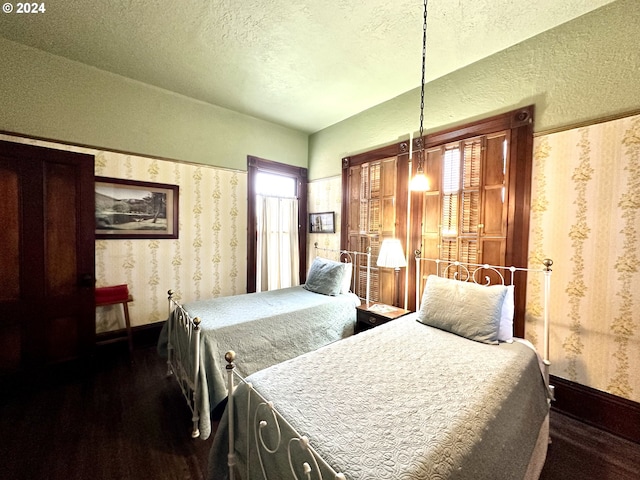 bedroom featuring dark wood-type flooring and a textured ceiling