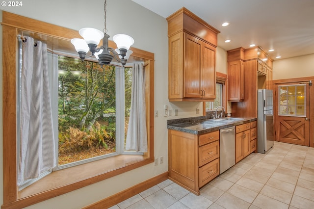 kitchen featuring a notable chandelier, plenty of natural light, sink, and appliances with stainless steel finishes