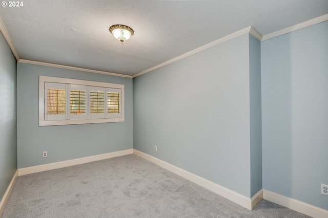 carpeted empty room featuring crown molding and a textured ceiling