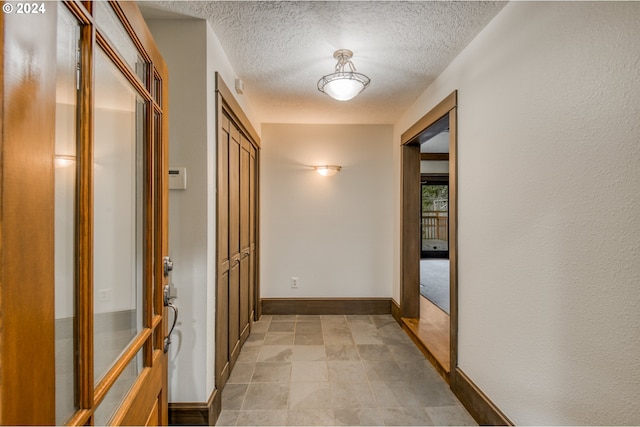 hallway featuring a textured ceiling